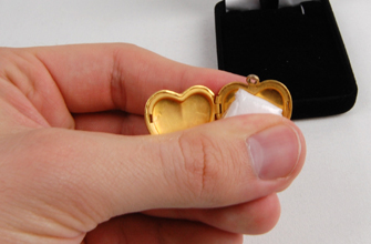 Placing the cremains inside the locket
